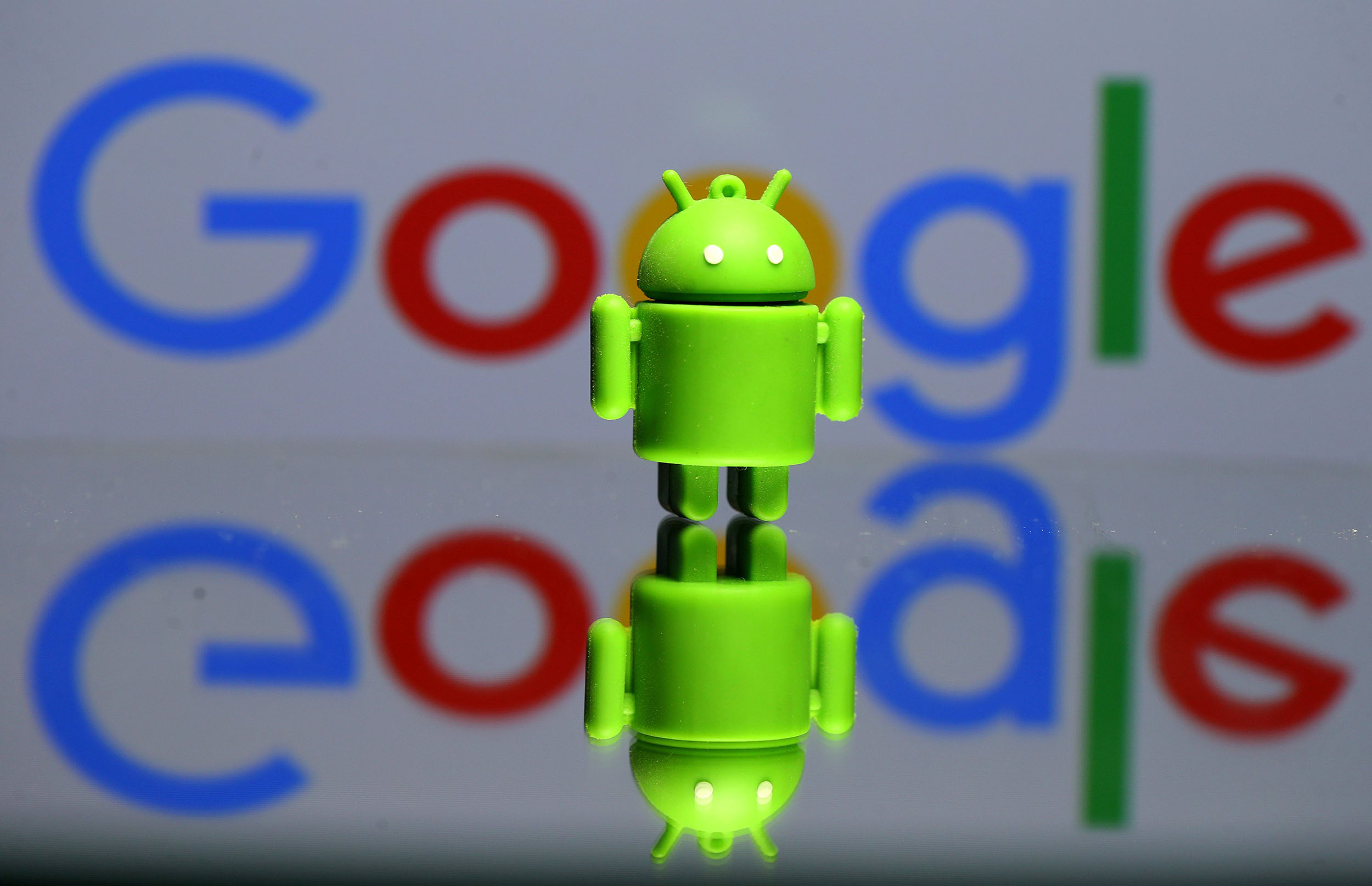 FILE PHOTO - A 3D printed Android mascot Bugdroid is seen in front of a Google logo in this illustration taken July 9, 2017. Picture taken July 9, 2017. REUTERS/Dado Ruvic/Illustration/r/File Photo